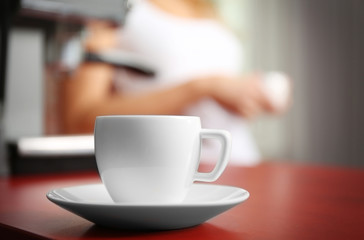 Cup of fresh coffee on kitchen table