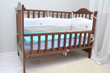 baby cot made of wood in the room