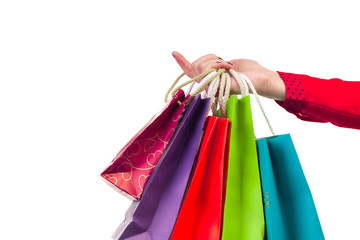 Multicoloured and bright shopping packages hanging on female red