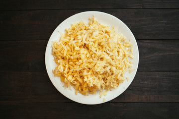 The raw grated potato on a plate