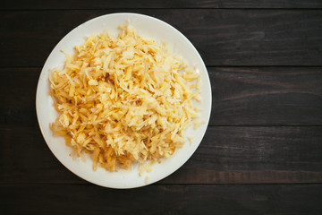 The raw grated potato on a plate