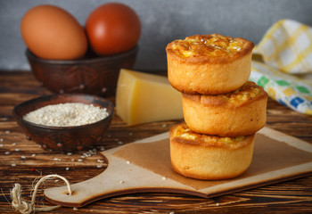 Mini pies with cheese, onion and egg. Tartlets. Delicious snack for gourmands. Selective focus
