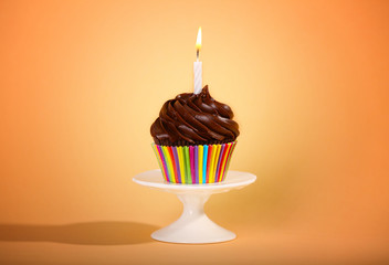 Tasty cupcake on color background