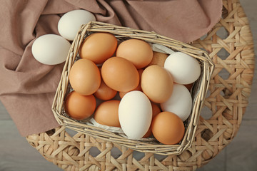Raw eggs in wicker basket, closeup
