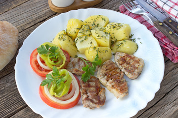 Grilled pork fillet meat and vegetables on plate