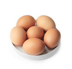 Raw eggs in plate on white background
