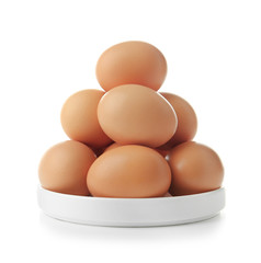 Raw eggs in plate on white background