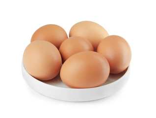 Raw eggs in plate on white background