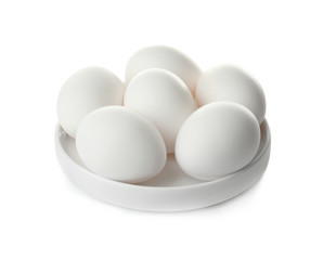 Raw eggs in plate on white background