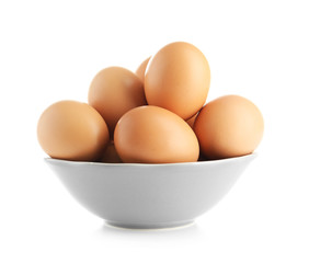 Raw eggs in bowl on white background
