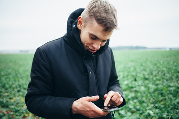 Man standing on the street and looking at the phone