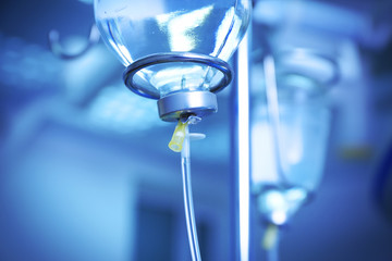 Infusion drip in hospital on blurred background