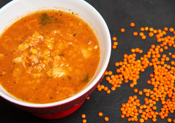 Red lentil soup on dark stone backgroud