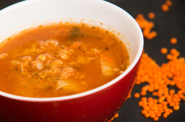 Red lentil soup on dark stone backgroud