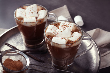Cups of hot cocoa with marshmallows on tray, closeup