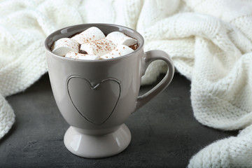 Cup of hot cocoa with marshmallows on table