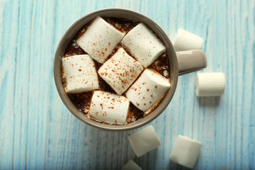 Cup of hot cocoa with marshmallows on table