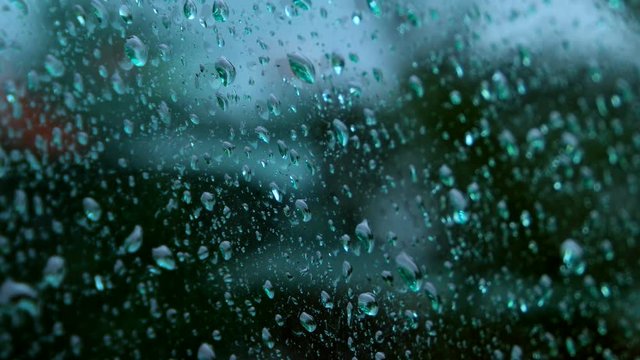 Close up of water drops running on glass