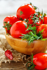 Salty cherry tomatoes in a wooden bowl.