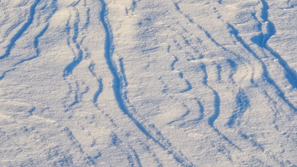 Snow drifts pattern. Abstract natural pattern of snow dunes at sunset