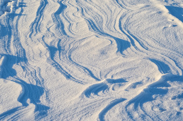 Snow drifts pattern. Abstract natural pattern of snow dunes at sunset