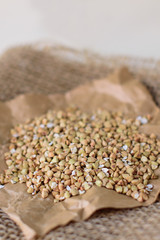 Buckwheat on white wooden background, close - up