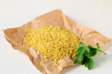 Bulgur wheat on wooden background