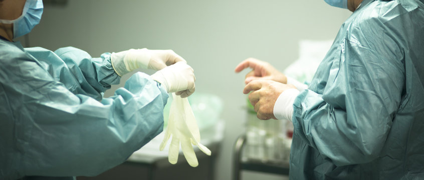 Surgeon Putting On Gloves