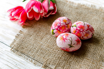 Decorated with painted Easter eggs and flowers on a light background