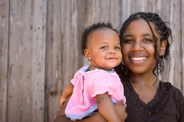 African American teenage mother and her daughter. - Powered by Adobe