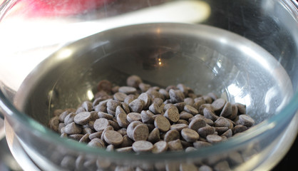 Black chocolate chips in the glass bowl