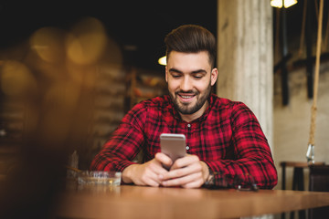 Handsome man looking at smartphone.