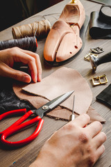cobbler tools in workshop dark background close up