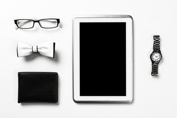 Gentleman kit of tablet watch glasses bow tie and notebook on wo