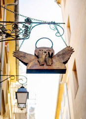 Vintage angel covering mouth at the streets of Aix-En-Provence