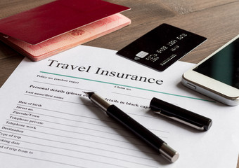 concept booking travel insurance on wooden background