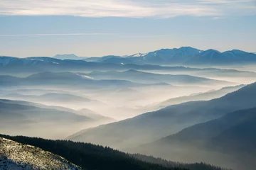 Zelfklevend Fotobehang Winter mountain hills with fog © gilitukha