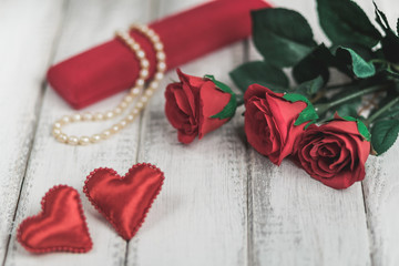 Red roses and Valentine's day hearts on wooden background. copy space