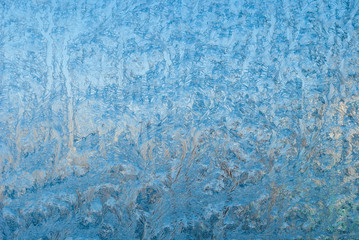 Fototapeta na wymiar Beautiful winter frost and the curls of ice on glass. This is frosty pattern window. Patterns A ,Close Up. at