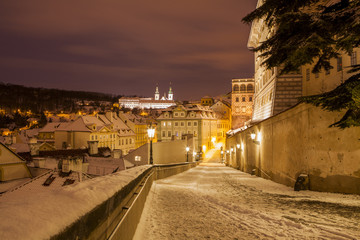 Fototapeta premium Winter in Prague, beautiful snow evening, view from the heights of Prague Castle Winter in Prague, beautiful snow evening, view from the heights of Prague Castle 