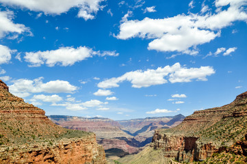 Stunning view of Grand Canyon National Park in Arizona, USA. Sunny day with clouds. Grand Canyon a gorge of the Colorado River, which is considered one of the Seven Natural Wonders of the World.