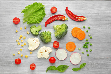 Fresh vegetables on wooden background, top view