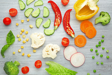 Fresh vegetables on wooden background, top view