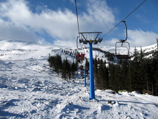 People go on the chairlift ski lift in the mountains Dragobrat t