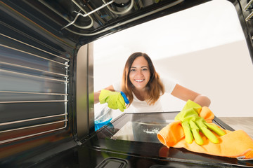 Woman Cleaning Inside The Oven