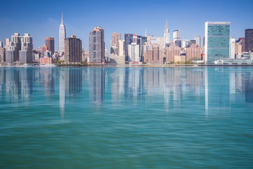 New York City view of Manhattan and The East River with reflections of NYC buildings. 
