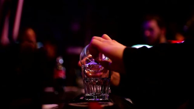 Barmen cooking Sambuca at the bar
