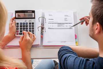 Couple Calculating Invoice