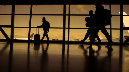 Obraz premium Passengers waiting to boarding. A sunny day blue sky on the background, silhouette, warm