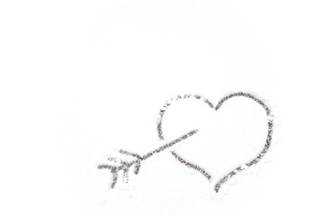 drawing heart and arrow on white snow background